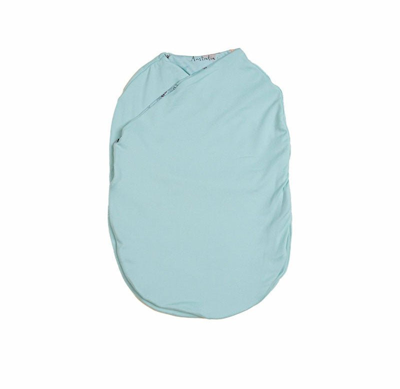 Reversible newborn baby cocoon swaddle featuring World Traveler design Silky Modal fabric.