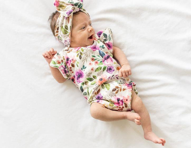 Ivory wildflowers design flutter sleeve baby onesie and knotty beanie in classic brushed fabric.