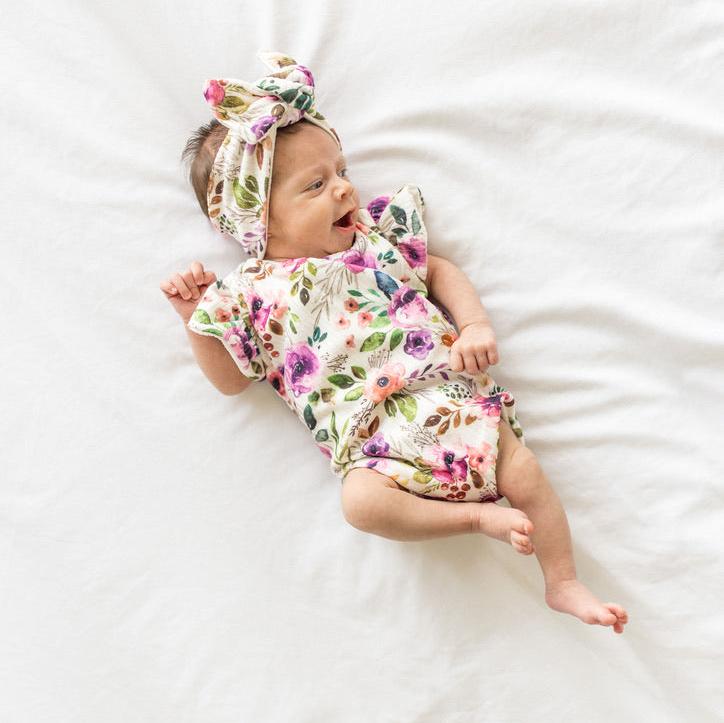 Ivory wildflowers design flutter sleeve baby onesie and knotty beanie in classic brushed fabric.