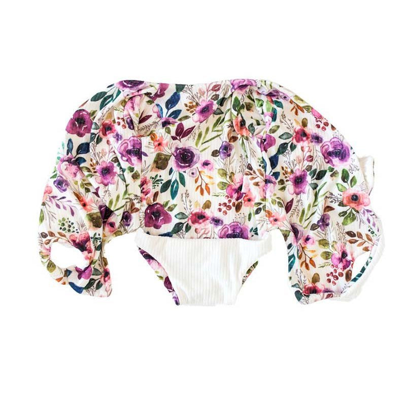 Comfortable Ivory Wildflowers design brushed fabric baby bodysuit with wings and ruffle trim cuffs.