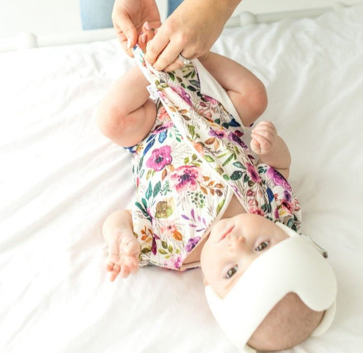 Baby short-sleeve bodysuit in Ivory Wildflowers print and Classic Brushed fabric styles.