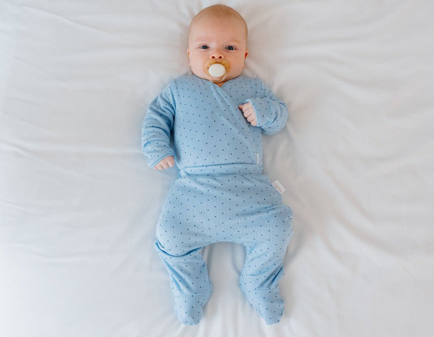 Reversible long-sleeve winged bodysuit and footie pants in Dotted Blues design.