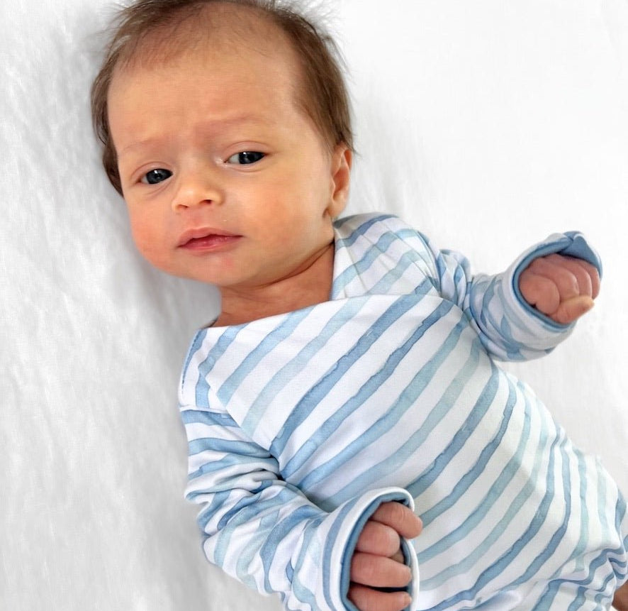 Reversible long-sleeve winged bodysuit in chambray waves design.