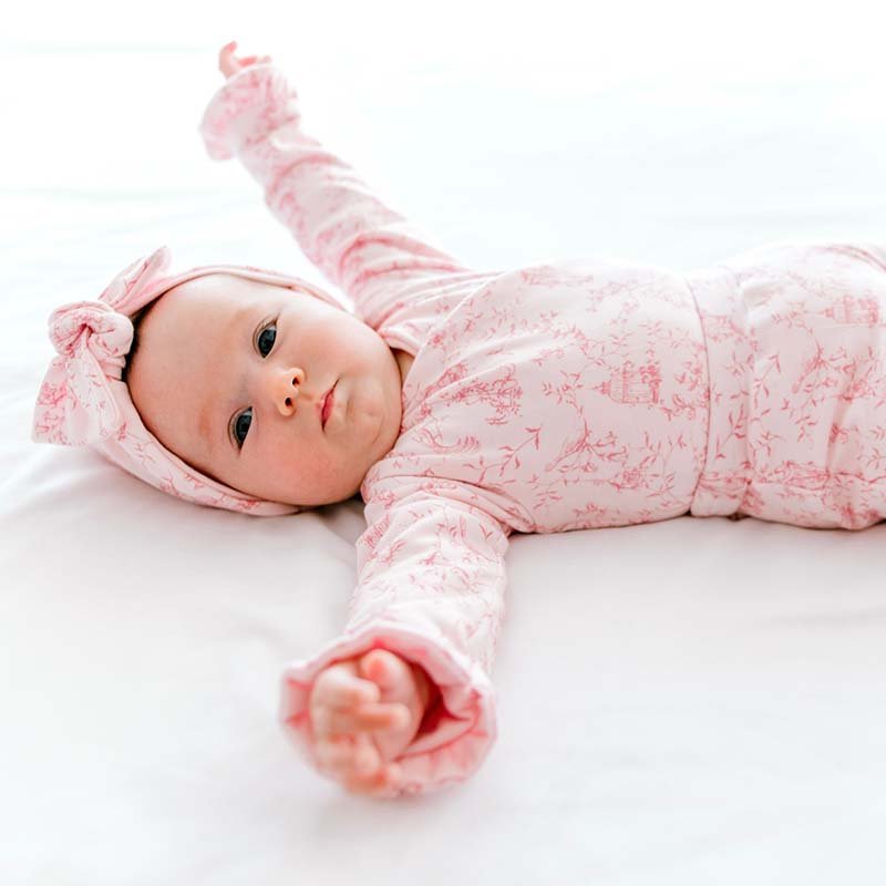 Whimsical garden ruffle cuff long sleeve baby onesie outfit bundle made from bamboo cotton.