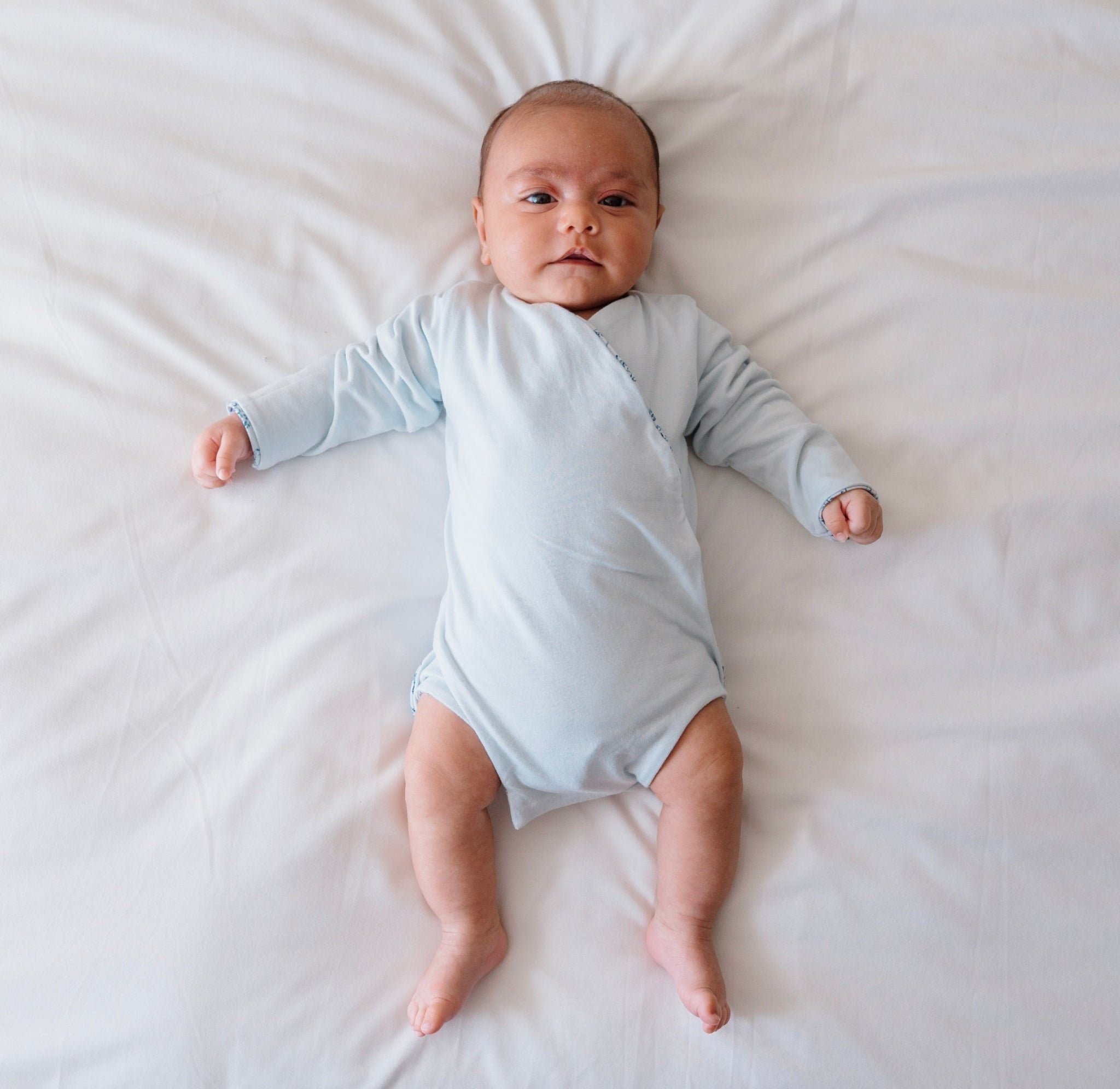 Reversible long-sleeve winged bodysuit for babies.