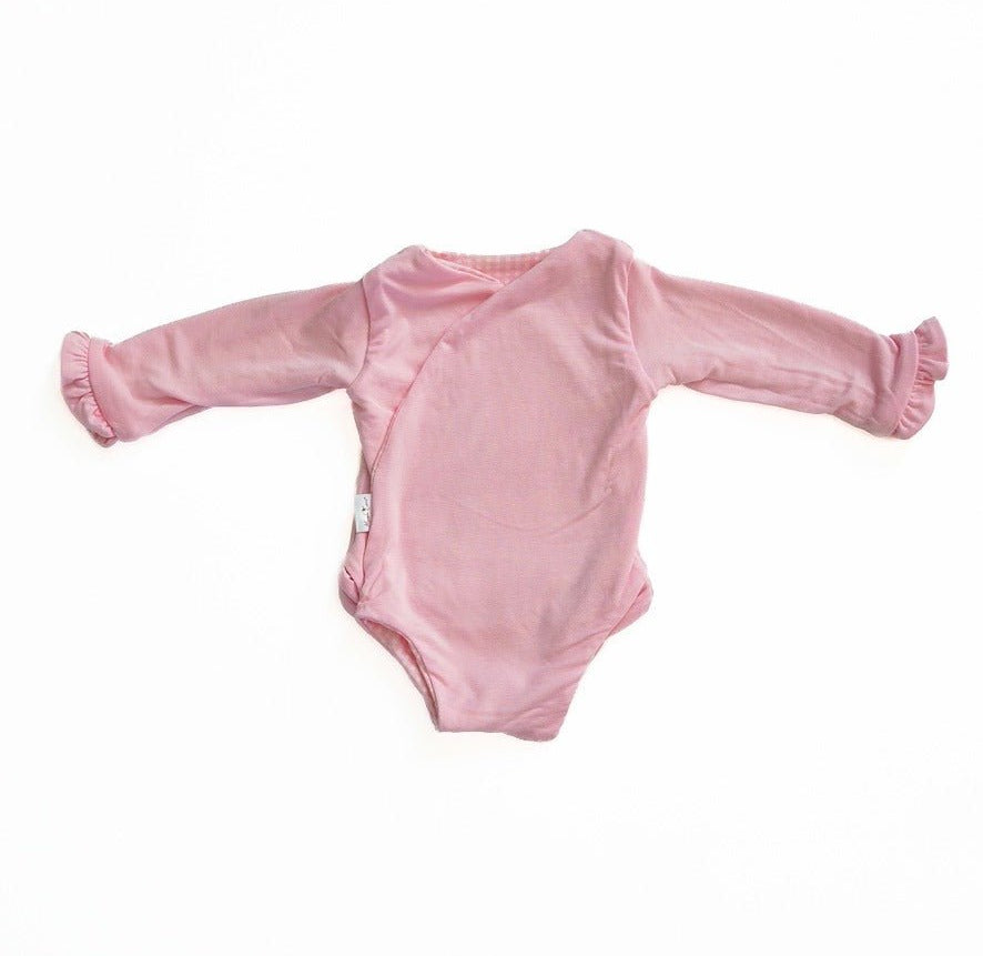 Long sleeved winged bodysuit for babies in silky modal fabric.