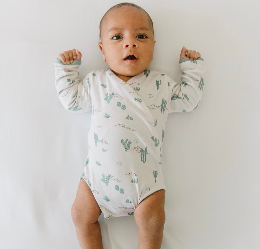Desert Sunsets design long-sleeved winged bodysuit.