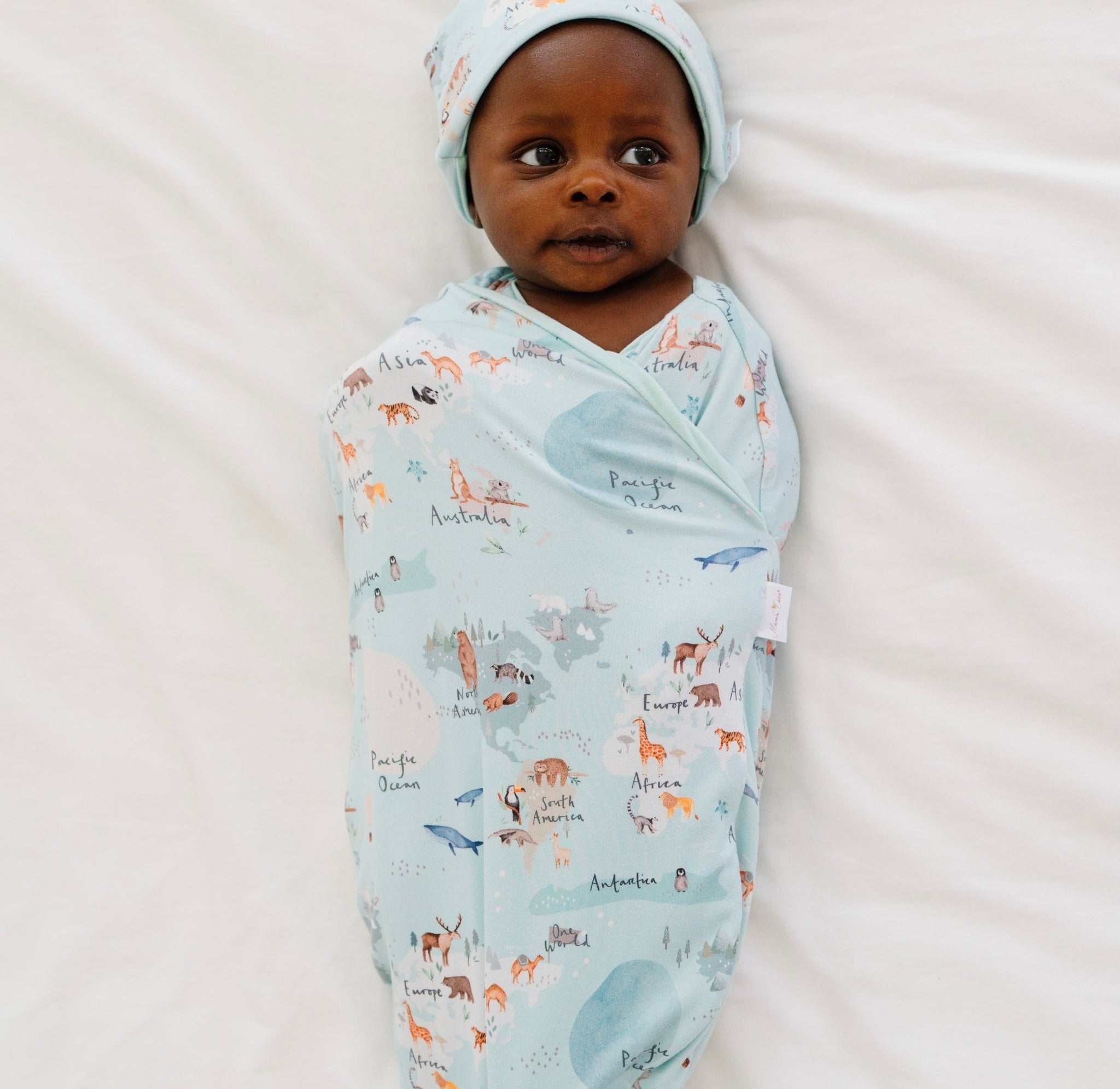 Classic-brushed short sleeve newborn essentials bundle in world traveler design.