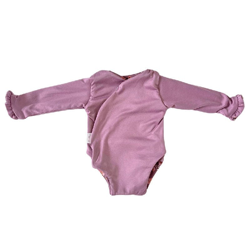 Stylish winged baby bodysuit with ruffle cuffs in soft Peachy Lilac design classic brushed fabric with a reversible design.