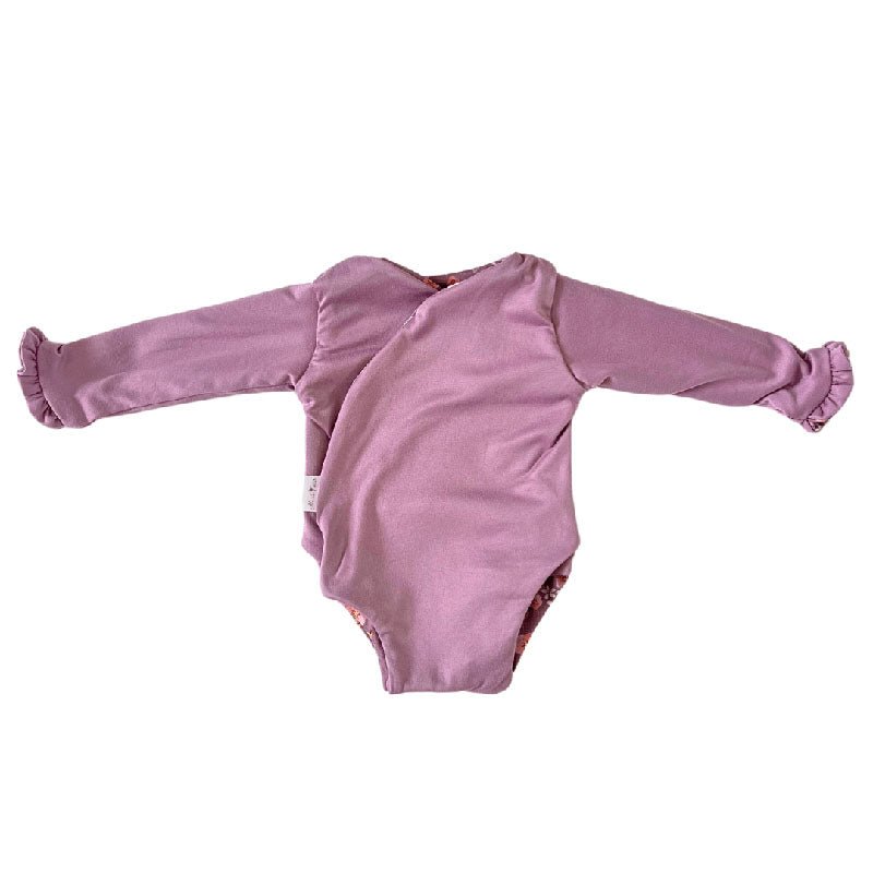Stylish winged baby bodysuit with ruffle cuffs in soft Peachy Lilac design classic brushed fabric with a reversible design.