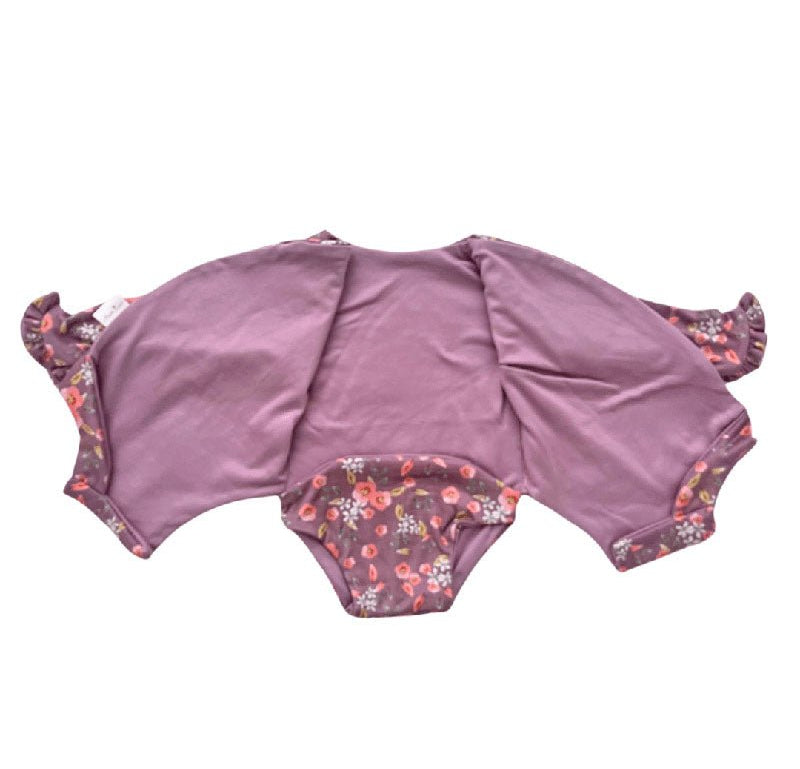 Winged long sleeve infant bodysuit crafted from cozy Peachy Lilac design reversible brushed fabric with ruffle cuf