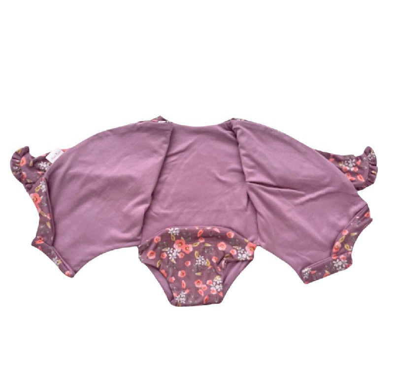 Winged long sleeve infant bodysuit crafted from cozy Peachy Lilac design reversible brushed fabric with ruffle cuf