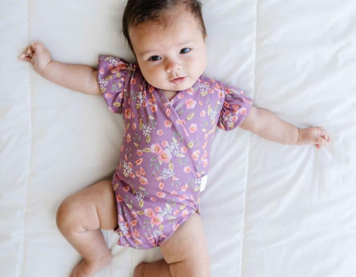 Peachy lilac design flutter sleeve baby onesie and knotty beanie in classic brushed fabric.