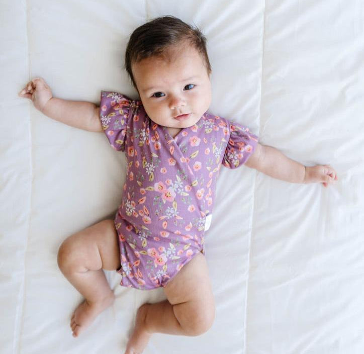 Peachy lilac design flutter sleeve baby onesie and knotty beanie in classic brushed fabric.
