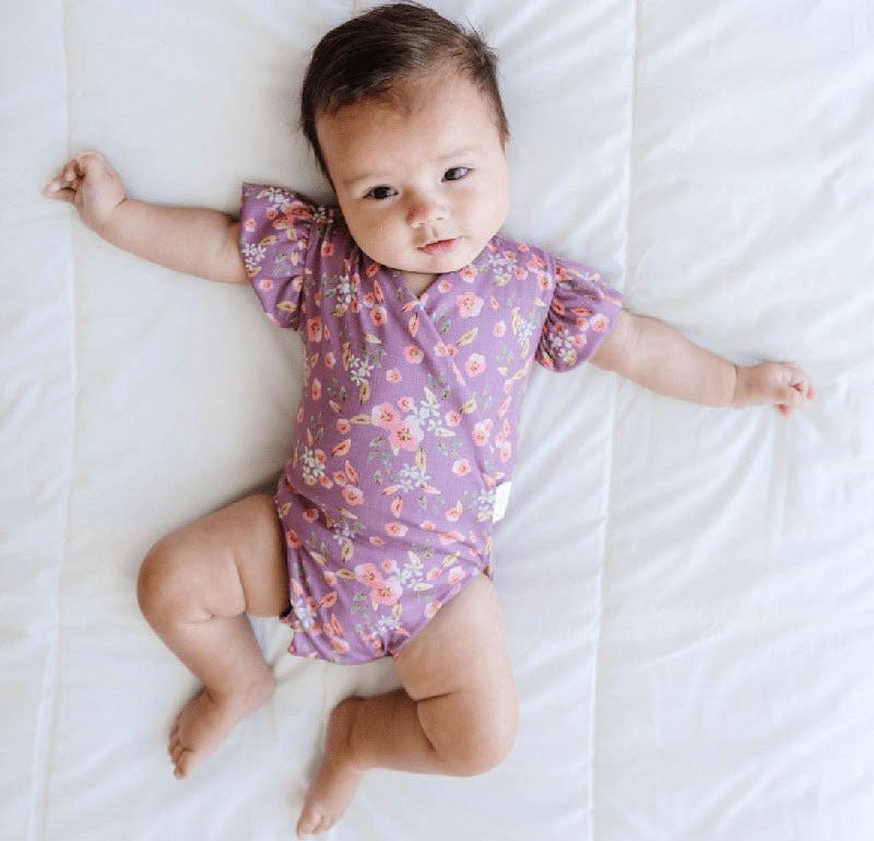 Peachy Lilac baby bodysuit with short sleeves crafted in soft Classic Brushed fabric styles.