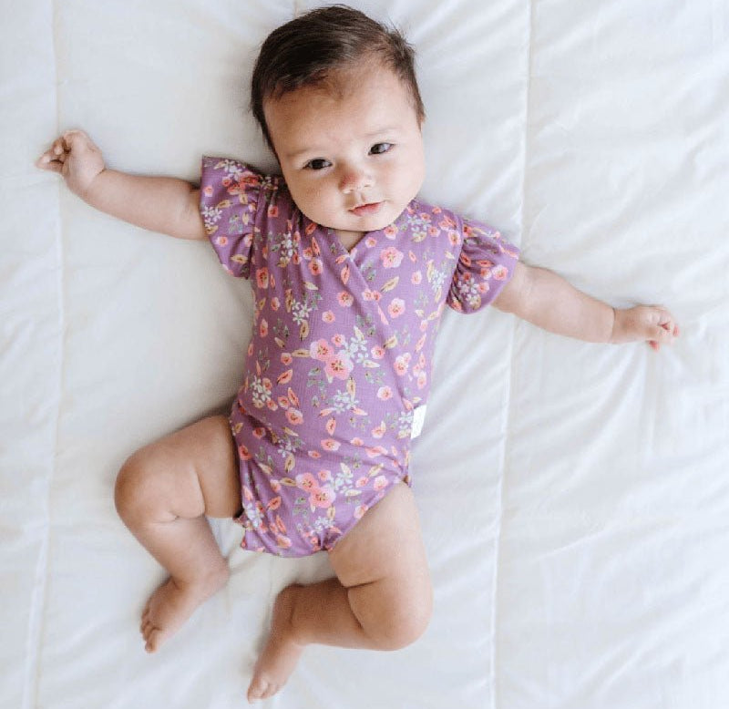 Peachy Lilac baby bodysuit with short sleeves crafted in soft Classic Brushed fabric styles.