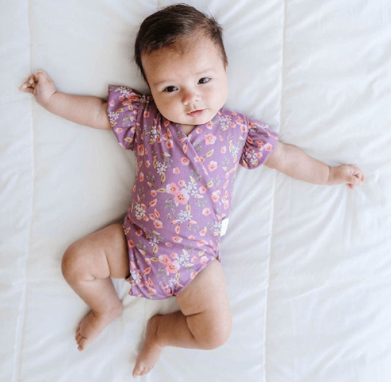 Peachy Lilac baby bodysuit with short sleeves crafted in soft Classic Brushed fabric styles.