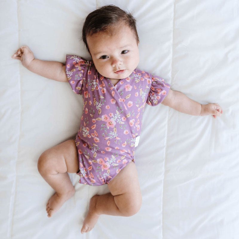 Peachy Lilac baby bodysuit with short sleeves crafted in soft Classic Brushed fabric styles.