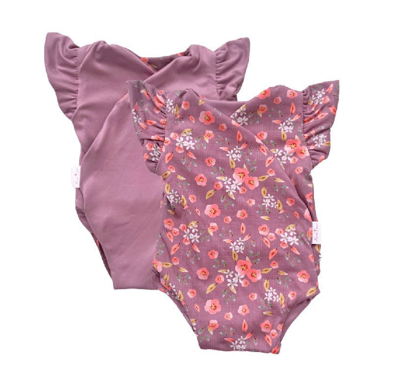 Reversible short-sleeve bodysuit for baby showcasing Peachy Lilac and soft brushed fabric.