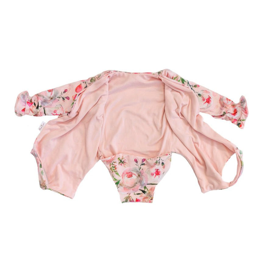Boutique-style long sleeve baby bodysuit with ruffle cuff accents in Peachy Rose Fields design brushed fabric.