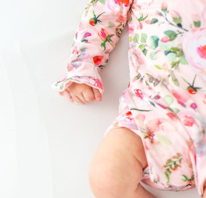 Classic brushed fabric baby bodysuit in Peachy Rose Fields design with long sleeves, winged, and ruffle cuffs.