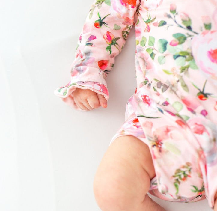 Classic brushed fabric baby bodysuit in Peachy Rose Fields design with long sleeves, winged, and ruffle cuffs.