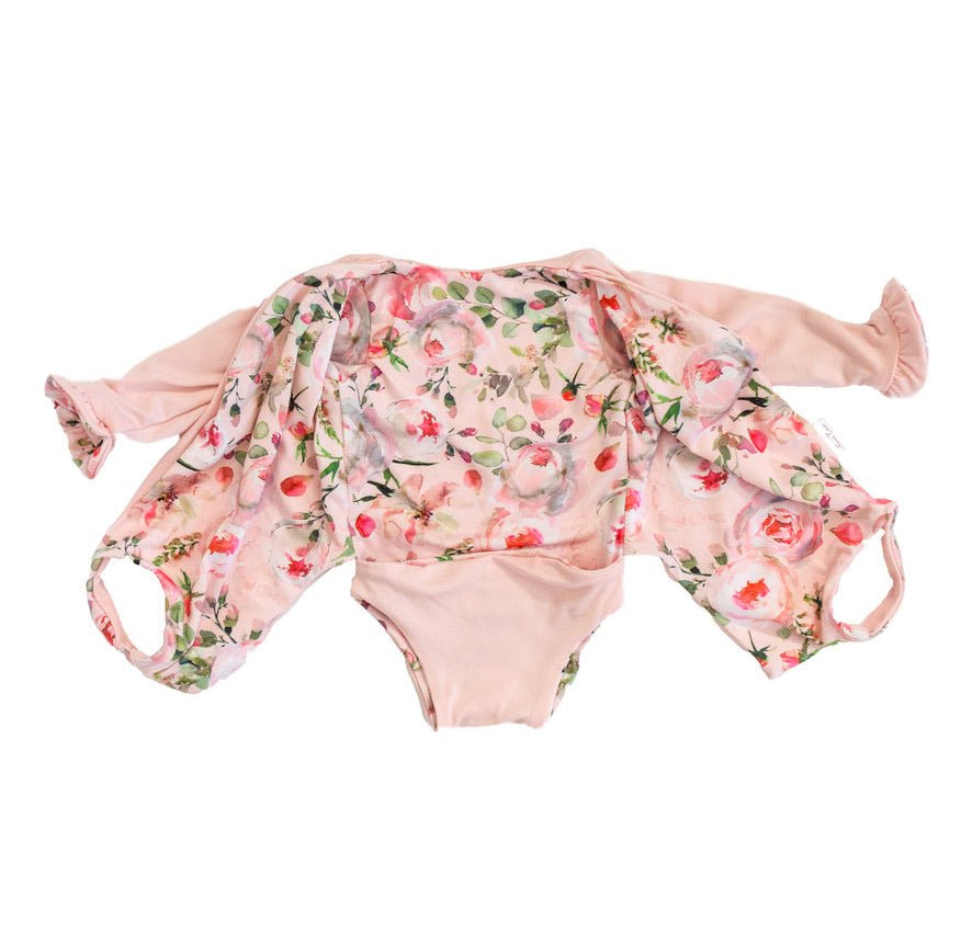 Long sleeve winged baby bodysuit featuring reversible ruffle cuffs in soft Peachy Rose Fields design brushed fabric.