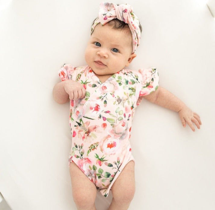 Peachy Rose Fields short-sleeve bodysuit for baby in Classic Brushed fabric styles with a floral design.