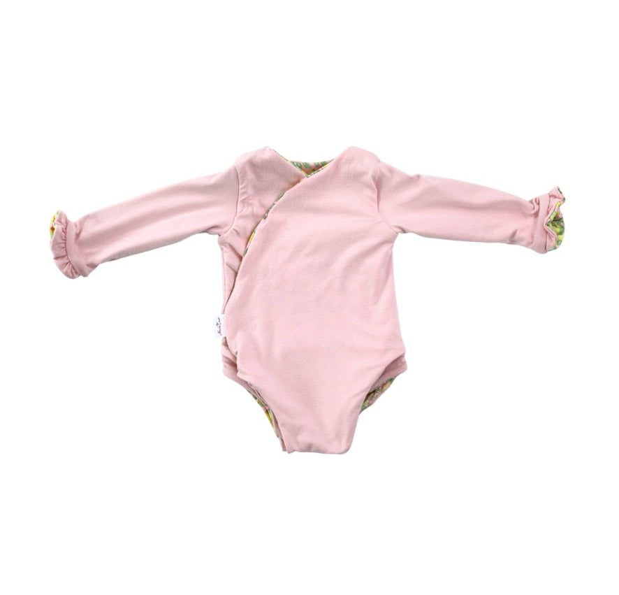 Long sleeve winged baby bodysuit featuring reversible ruffle cuffs in soft Pink Lemonade design brushed fabric.
