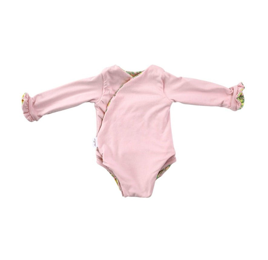 Long sleeve winged baby bodysuit featuring reversible ruffle cuffs in soft Pink Lemonade design brushed fabric.
