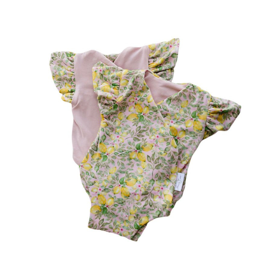Reversible Pink Lemonade floral baby bodysuit with comfortable short sleeves.
