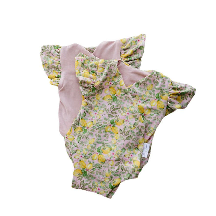 Reversible Pink Lemonade floral baby bodysuit with comfortable short sleeves.