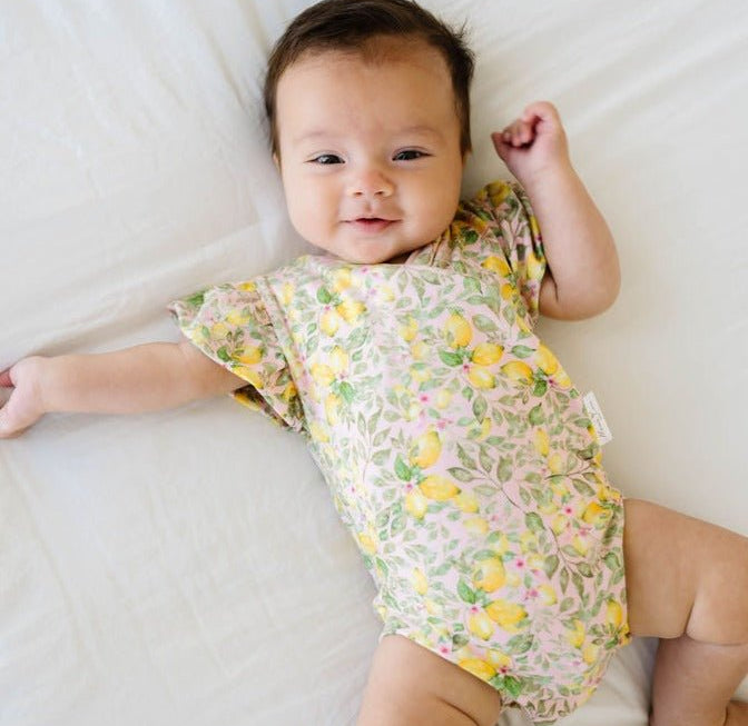 Baby short-sleeve bodysuit featuring Pink Lemonade and Classic Brushed fabric styles.