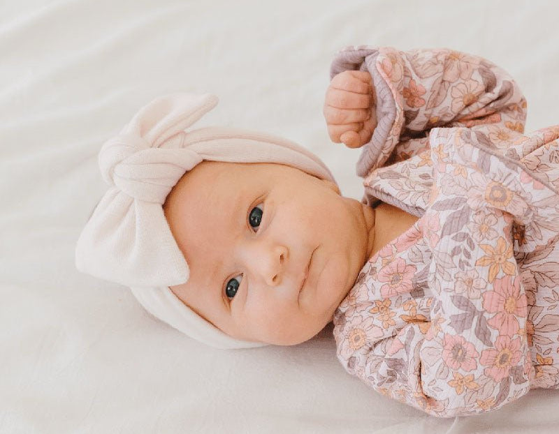 Soft and elegant baby headwrap with bow in Plush Pink Cashmere fabric.
