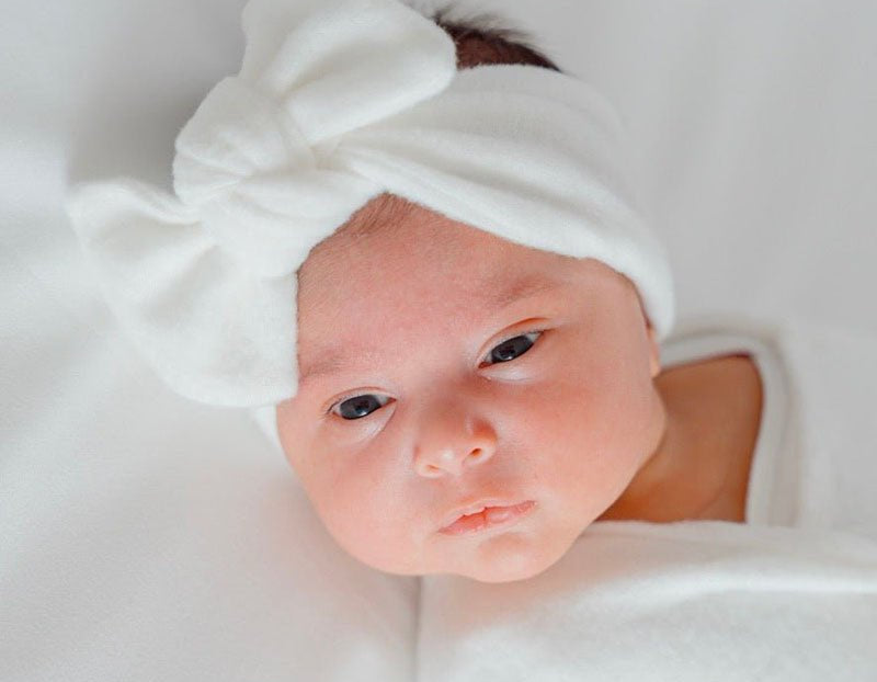 Baby headwrap with bow crafted in soft Plush Perfection fabric.