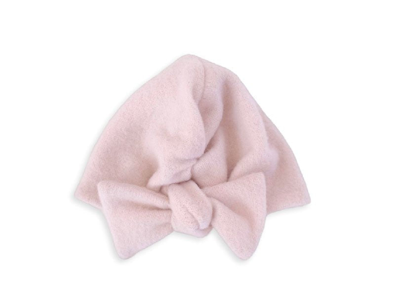 Ruched beanie with bow crafted in soft Plush Pink Cashmere design Plush Dream fabric.