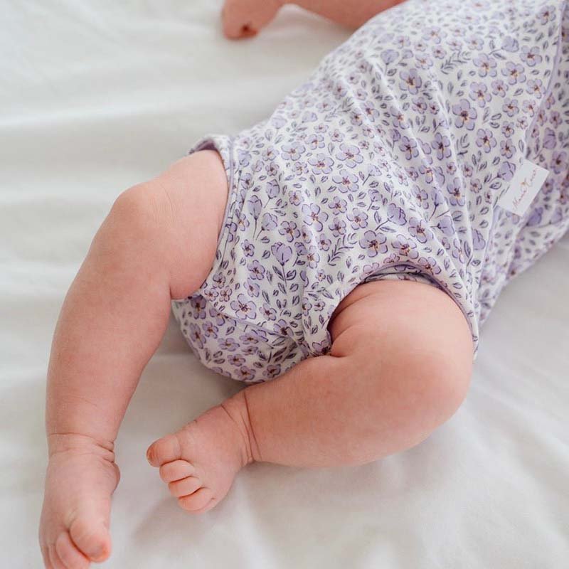 Purple Posies design flutter sleeve winged bodysuit for babies in silky modal fabric.