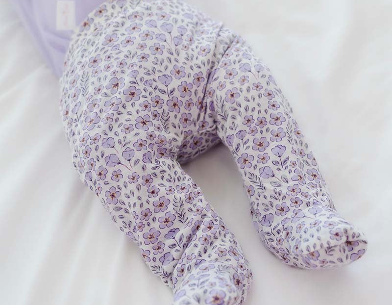 Purple Posies baby footie pants made with breathable silky modal fabric.