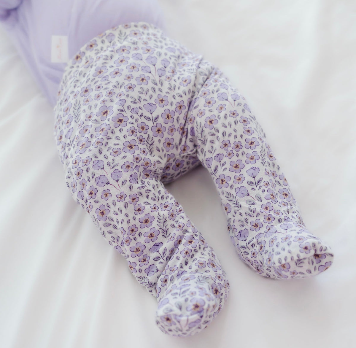 Baby footie pants in purple posies design.