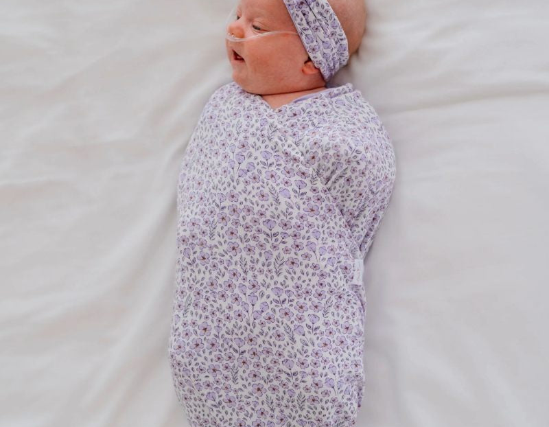 Purple posies design baby onesie outfit in silky modal fabric.