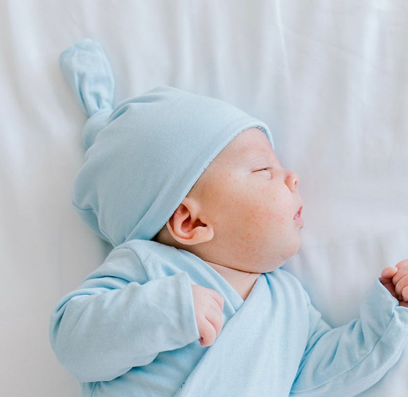 Reversible baby beanie in bon voyage design.