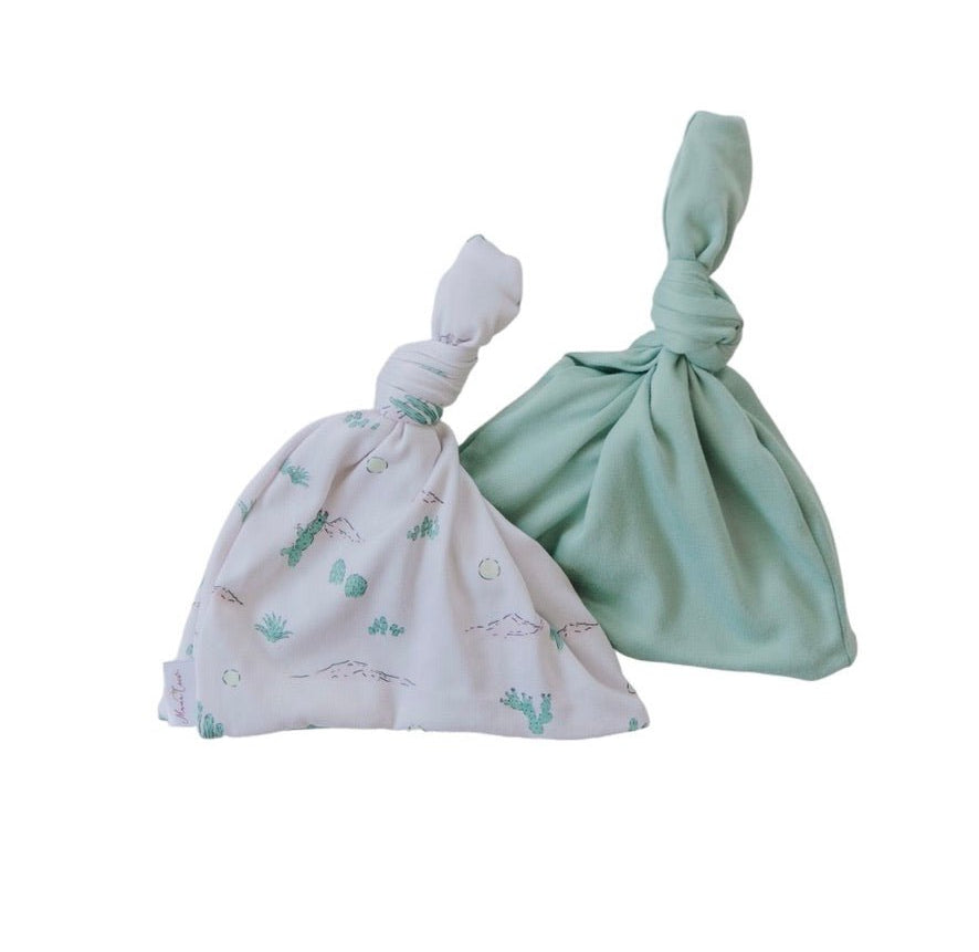 Soft reversible baby beanie in the Desert Sunsets design made from classic brushed fabric.