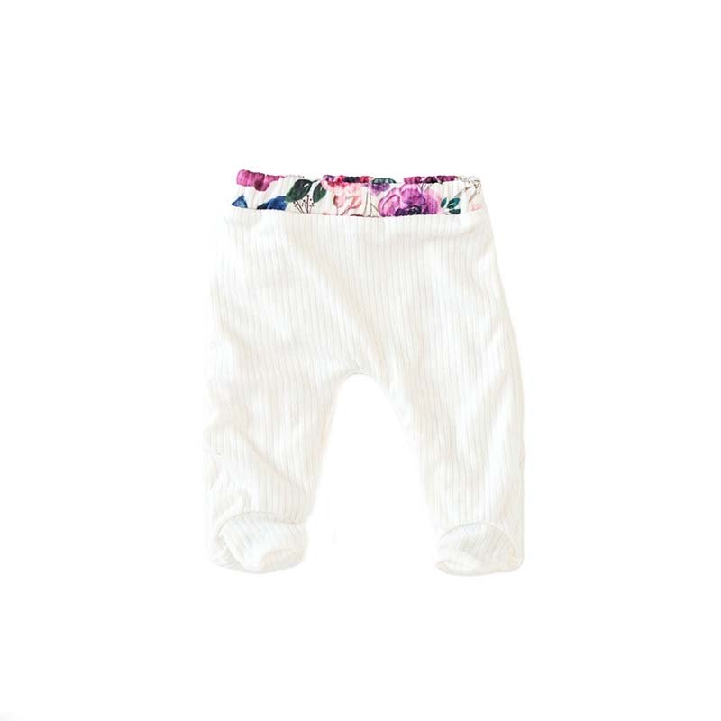 Reversible baby footie pants crafted from a soft bamboo cotton fabric featuring the Ivory Wildflowers print.