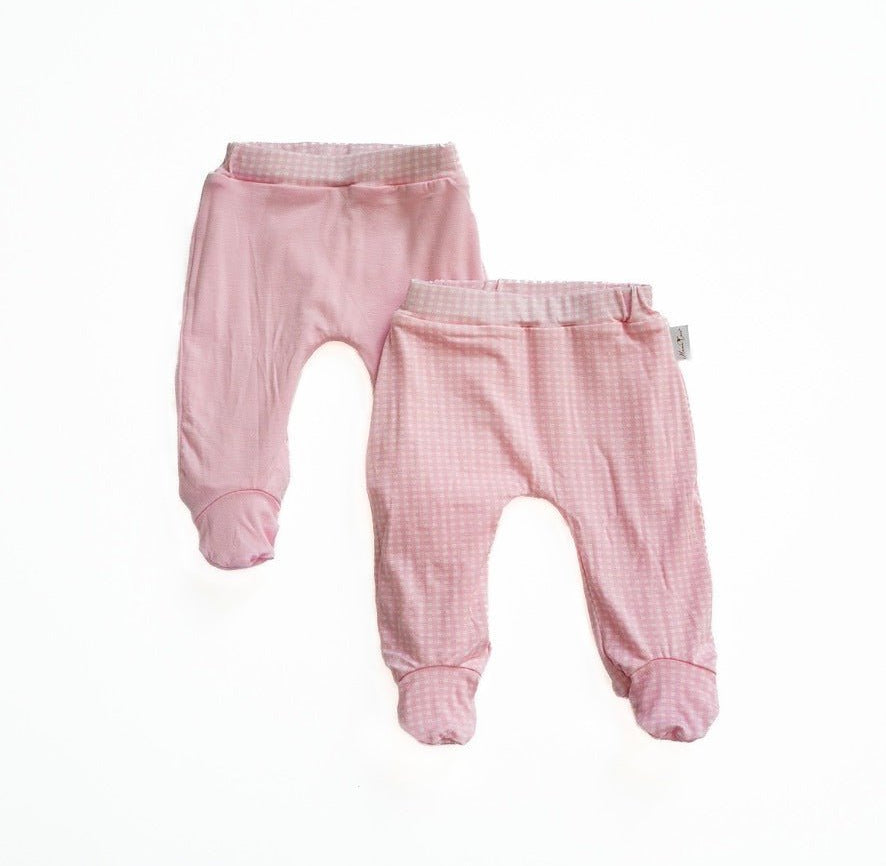 Reversible baby footie pants in pink gingham design.