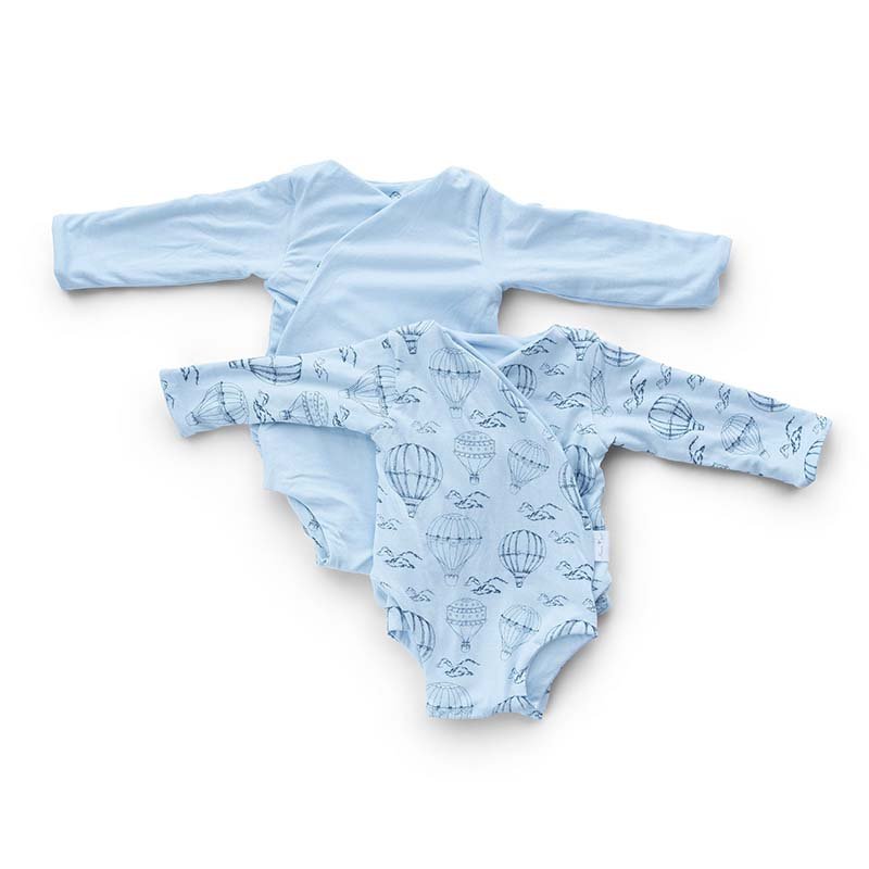 Reversible long-sleeve baby onesie in bon voyage design.