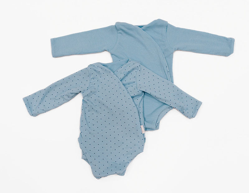 Reversible long sleeve silky modal onesie bodysuit in a dotted blue design.