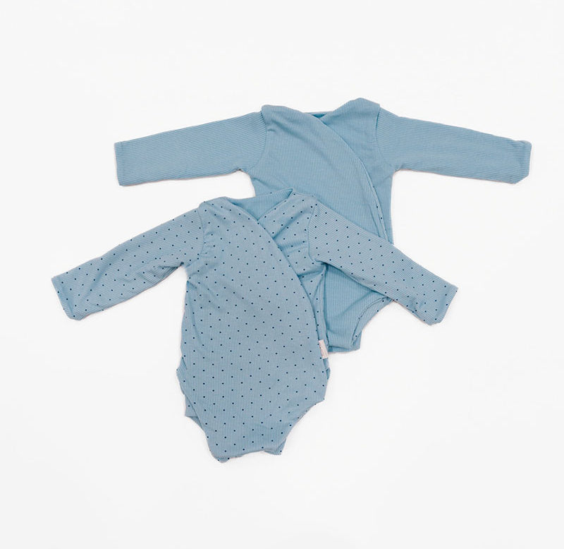 Reversible long-sleeve silky modal onesie bodysuit in a dotted blue design.