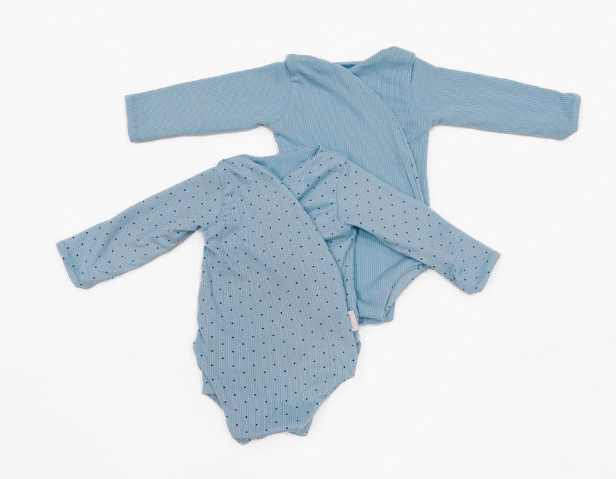 Reversible dotted blues design long-sleeve baby onesie in silky modal fabric.