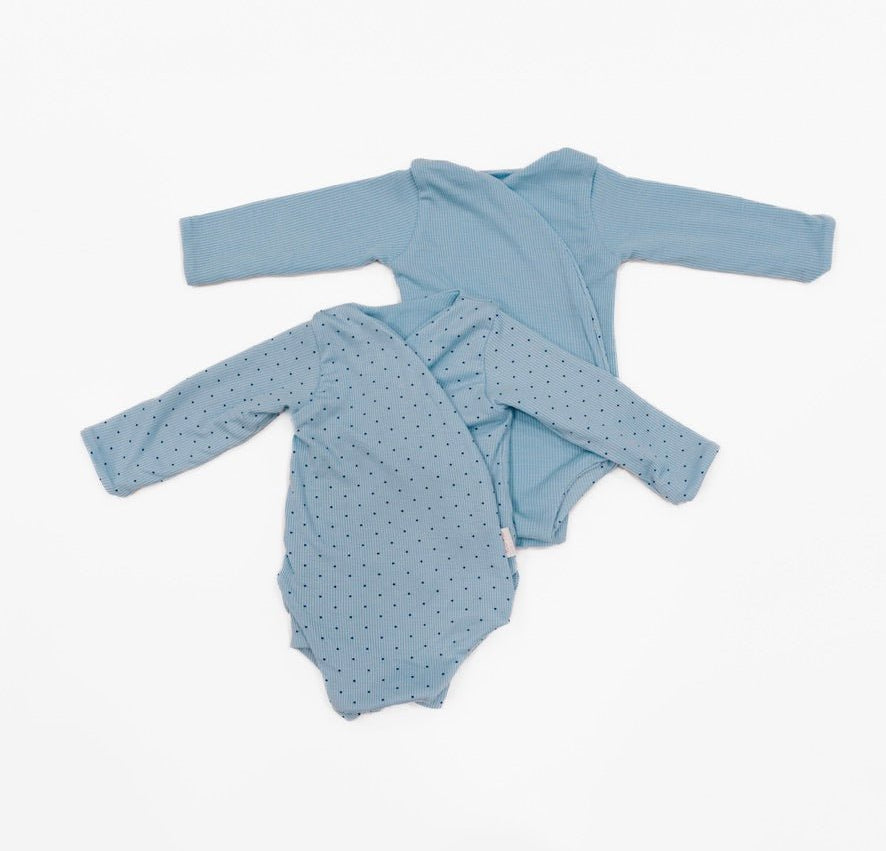 Reversible dotted blues design long-sleeve baby onesie in silky modal fabric.