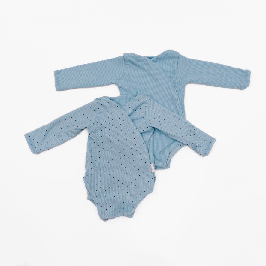 Reversible dotted blues design long-sleeve baby onesie in silky modal fabric.